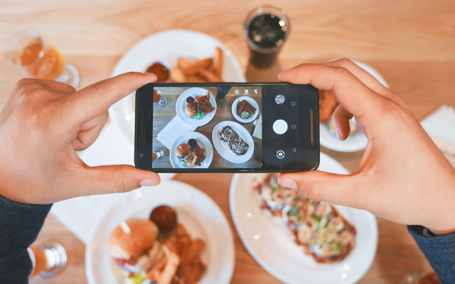 influencer taking a photo of food